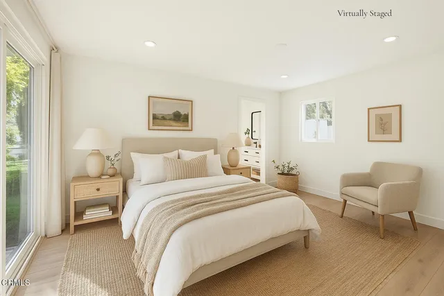 a bedroom with a bed and a chair