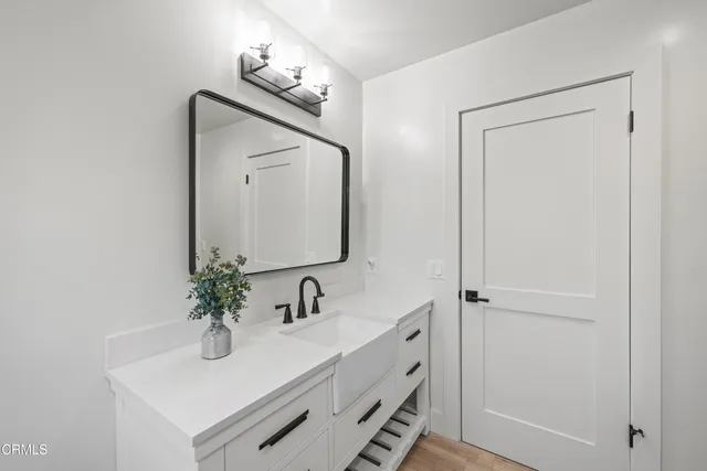 a bathroom with a sink vanity and mirror