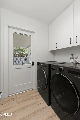 a utility room with sink dryer and washer