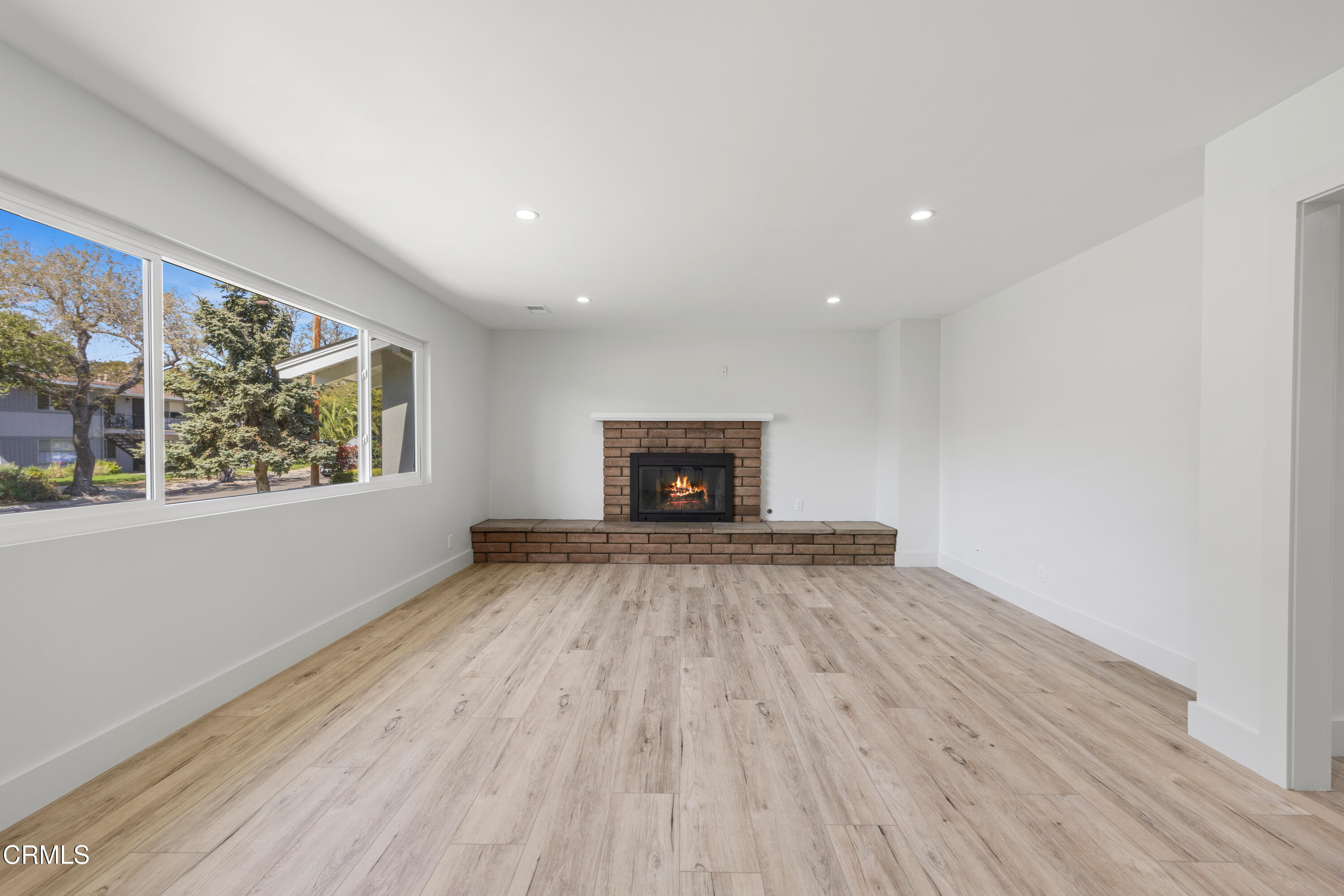 246 3rd Street Solvang, CA 93463 - Photo 5 of 33 a view of an empty room with wooden floor and a window