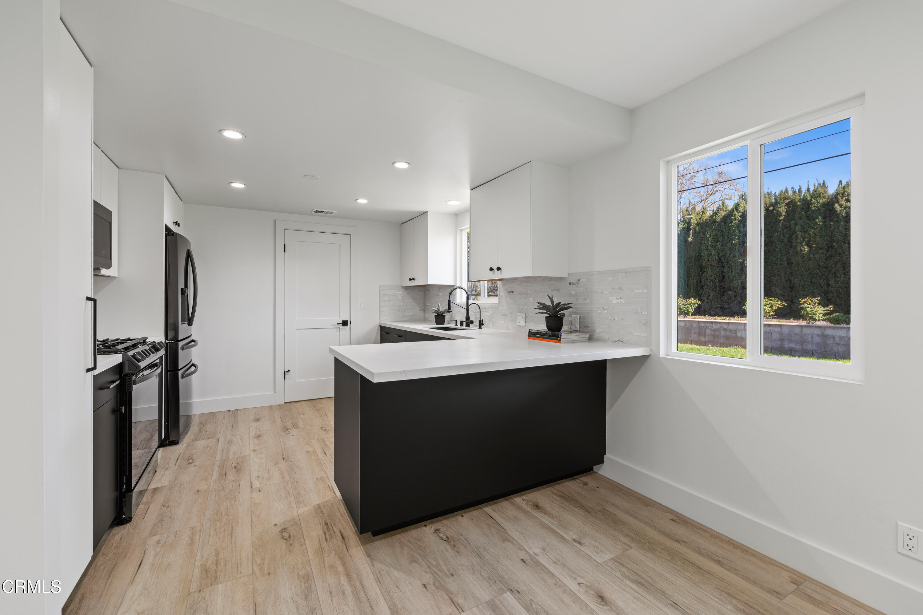 246 3rd Street Solvang, CA 93463 - Photo 9 of 33 a kitchen with stainless steel appliances granite countertop a sink stove and refrigerator