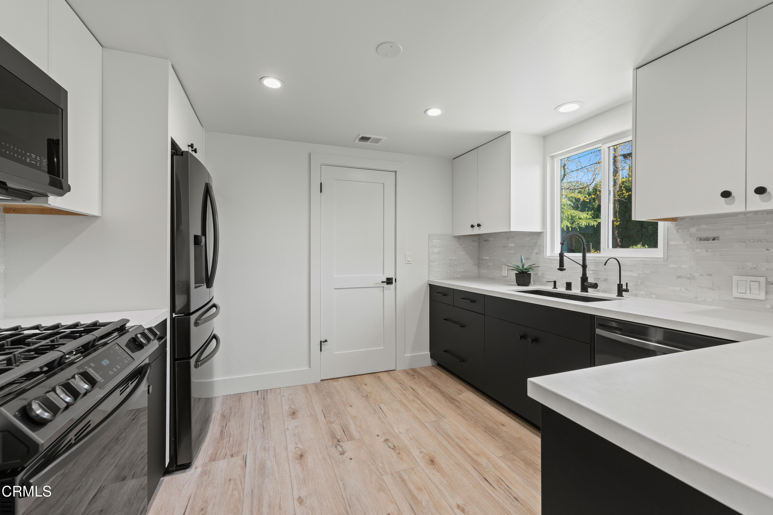 246 3rd Street Solvang, CA 93463 - Photo 10 of 33 a kitchen with a sink stove top oven and refrigerator