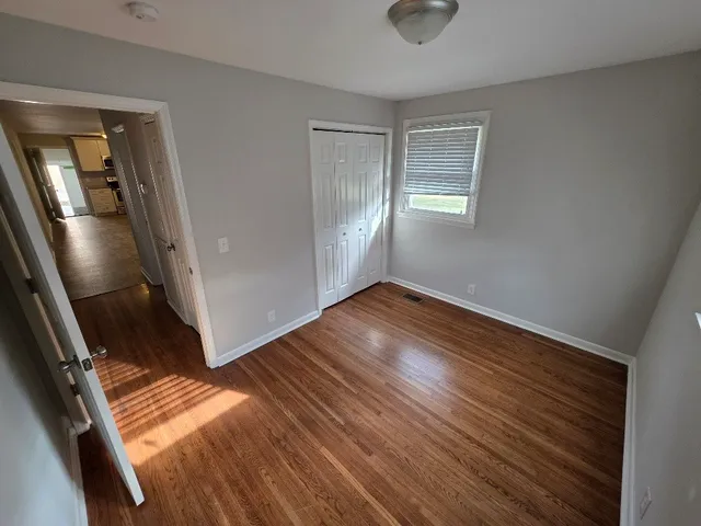 a bathroom with a granite countertop sink and a toilet