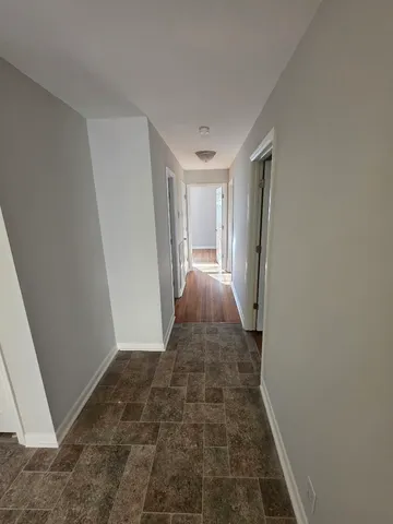 a view of a room with wooden floor and white walls