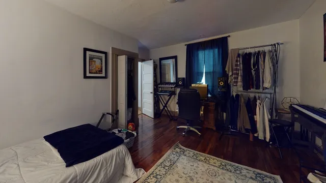 a living room with furniture rug and wooden floor