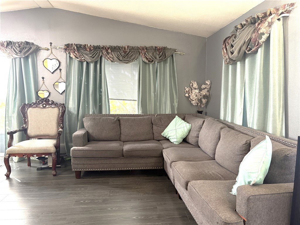 10745 Victoria Avenue, Unit 4 Whittier, CA 90604 - Photo 3 of 16 a living room with furniture and a large window