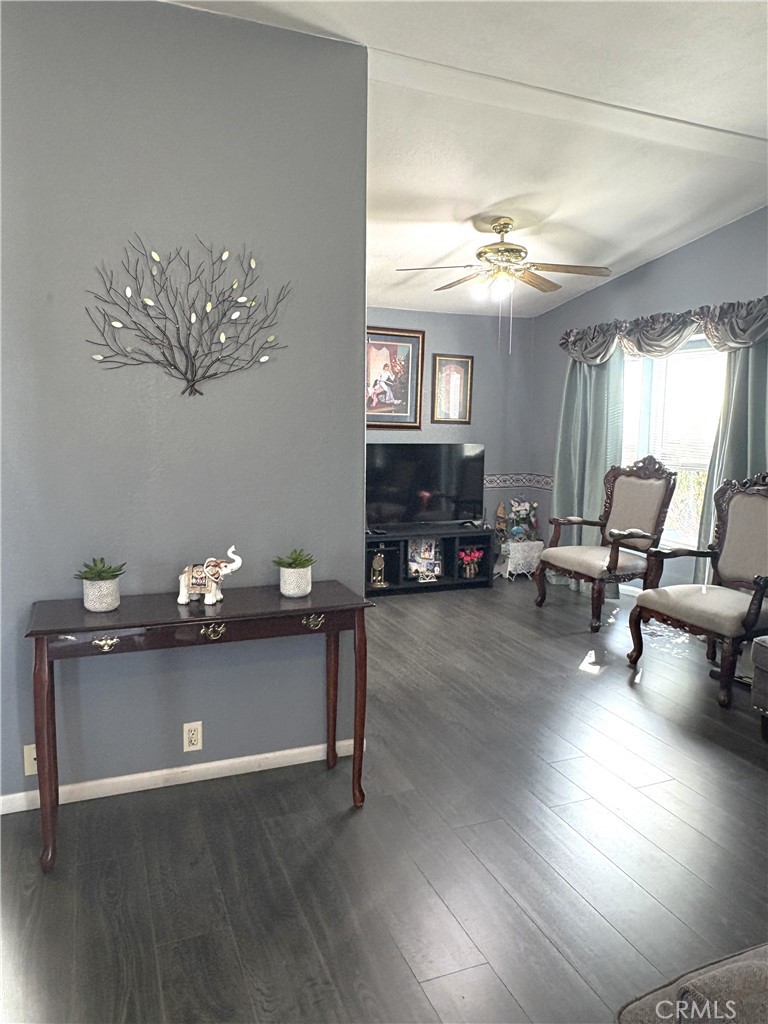 10745 Victoria Avenue, Unit 4 Whittier, CA 90604 - Photo 4 of 16 a living room with furniture and a chandelier