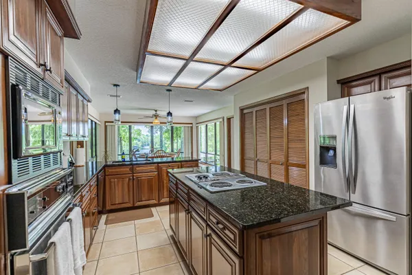 a living room with furniture pool table and a large window
