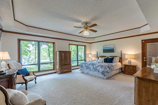 a bedroom with a bed and a chandelier