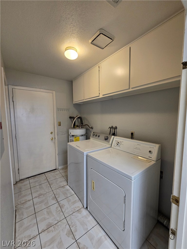 6750 Del Rey Avenue, Unit 133 Las Vegas, NV 89146 - Photo 29 of 34 Functional utility space equipped with laundry appliances and convenient upper cabinetry.