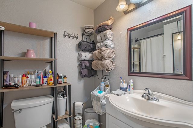 a bathroom with a sink a mirror and a toilet