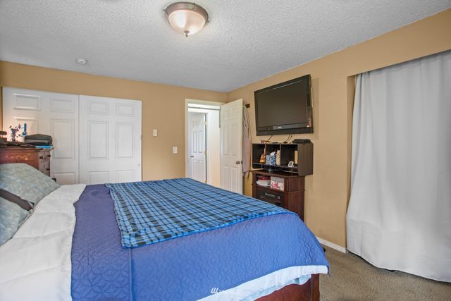 a bedroom with a large bed and a tv