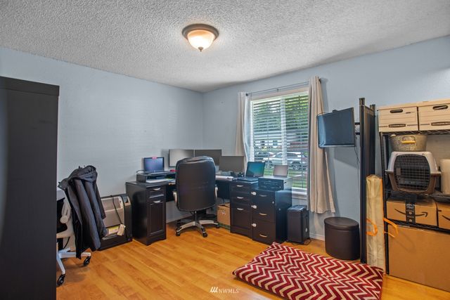 a view of a workspace with furniture and a window