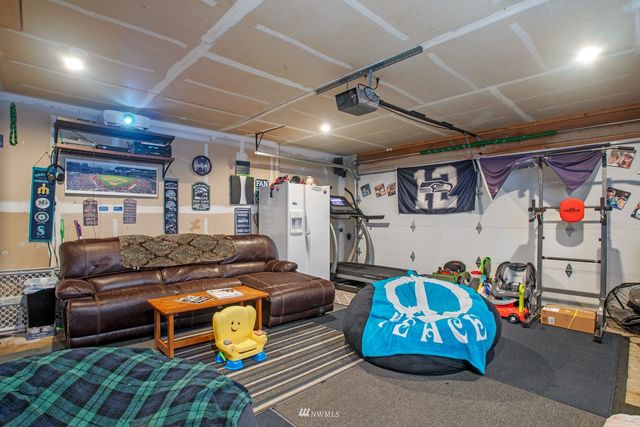 a bedroom with bed and a car parked