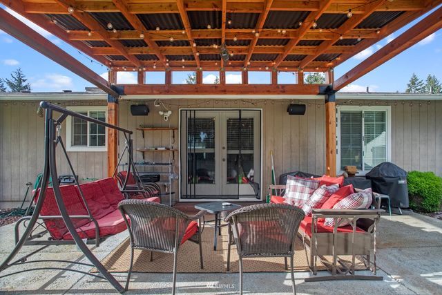 a patio with a table and chairs