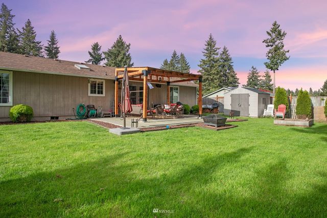 a view of a house with backyard sitting area and garden