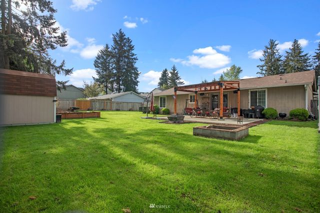 a swimming pool with outdoor seating and yard