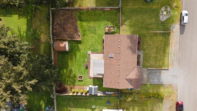 an aerial view of a house with a yard basket ball court and outdoor seating