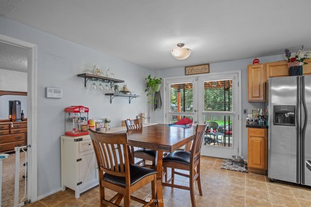 a view of a dining room with furniture a chandelier and wooden floor