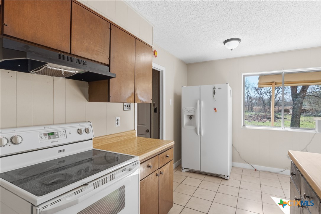 102 Runnel Street Seguin, TX 78155 - Photo 13 of 34 a kitchen with a stove and a refrigerator