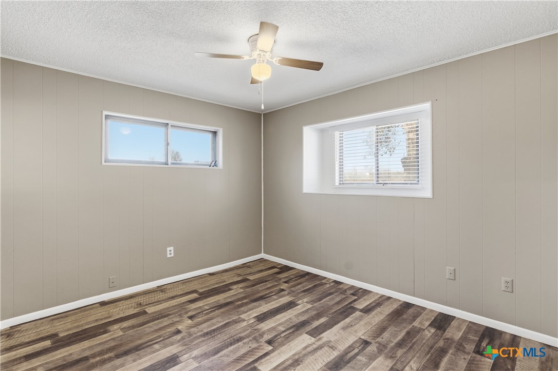 102 Runnel Street Seguin, TX 78155 - Photo 14 of 34 a view of a room with wooden floor and a ceiling fan