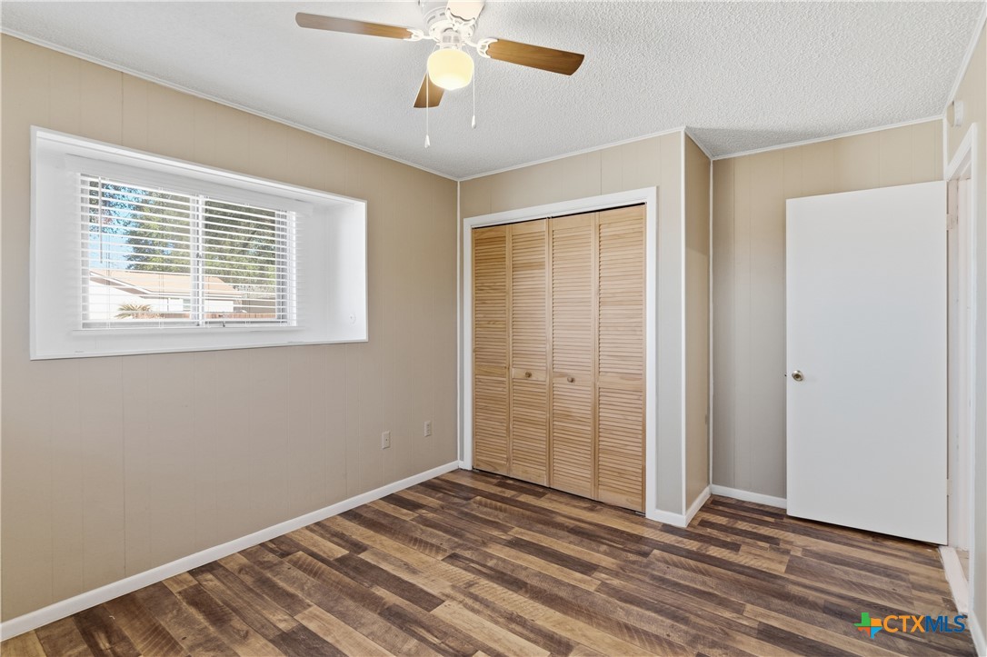 102 Runnel Street Seguin, TX 78155 - Photo 15 of 34 a view of an empty room with wooden floor and a window