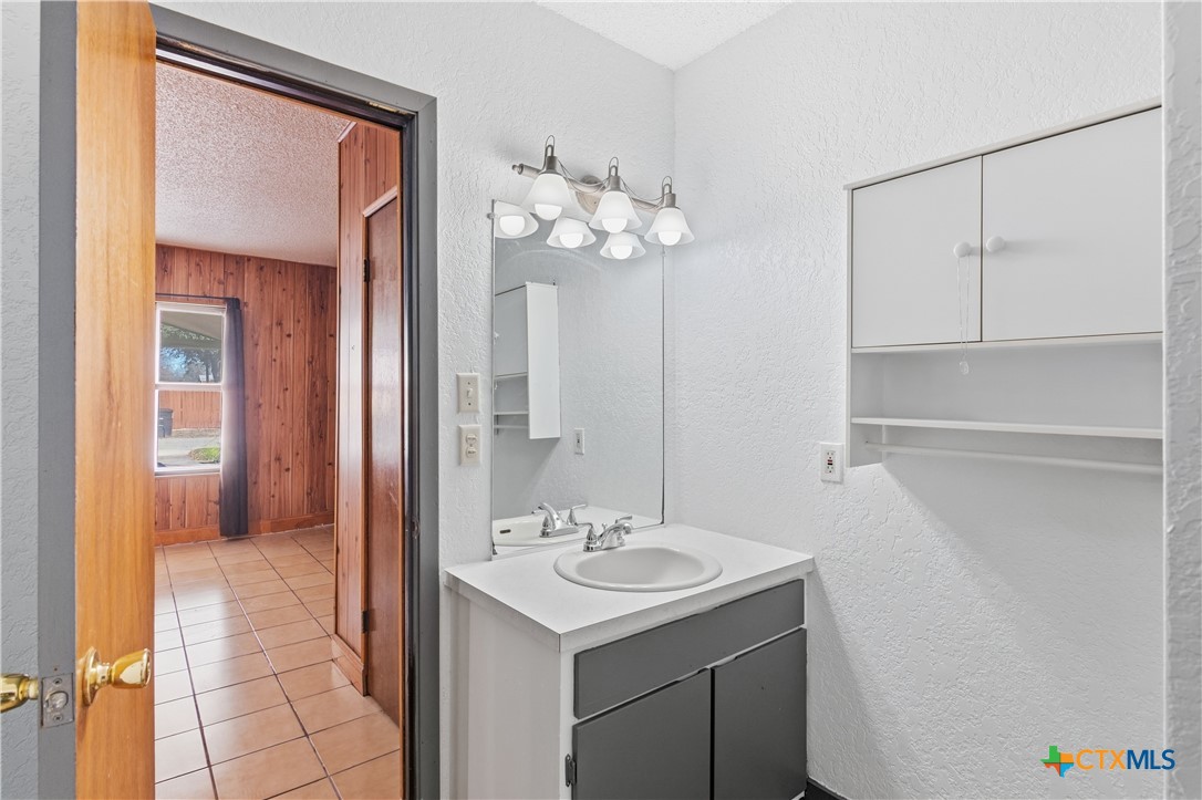 102 Runnel Street Seguin, TX 78155 - Photo 24 of 34 a bathroom with a sink a mirror and a shower