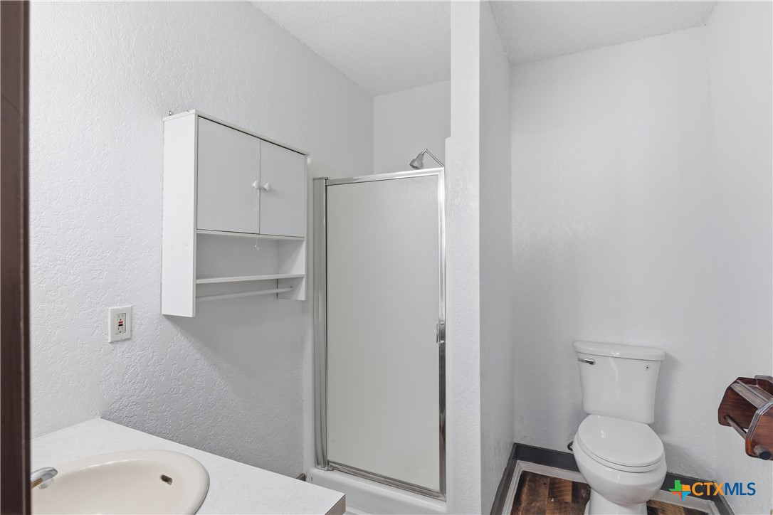 102 Runnel Street Seguin, TX 78155 - Photo 25 of 34 a white toilet sitting next to a bathroom sink