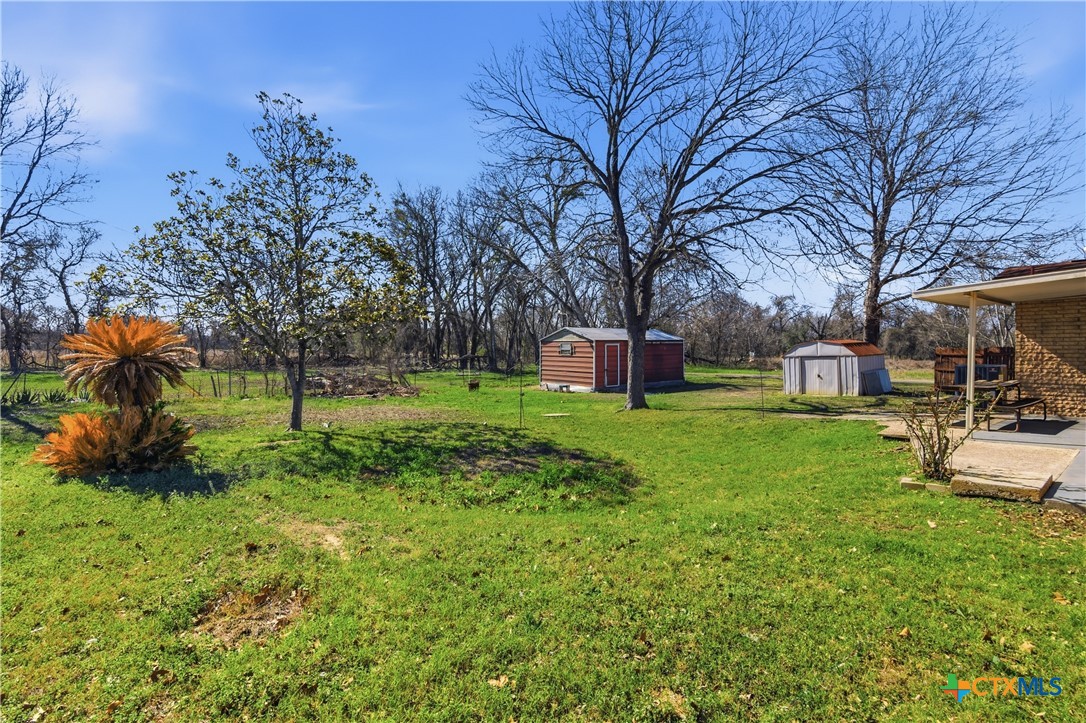 102 Runnel Street Seguin, TX 78155 - Photo 32 of 34 a front view of a house with garden and trees