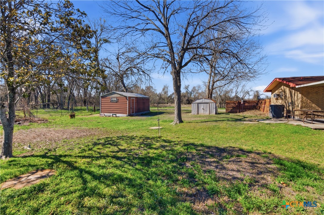 102 Runnel Street Seguin, TX 78155 - Photo 33 of 34 a front view of a house with garden and trees