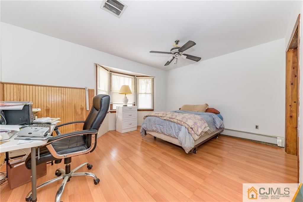 88 Emmans Road Ledgewood, NJ 07852 - Photo 13 of 25 a bedroom with a bed a desk and chair with wooden floor