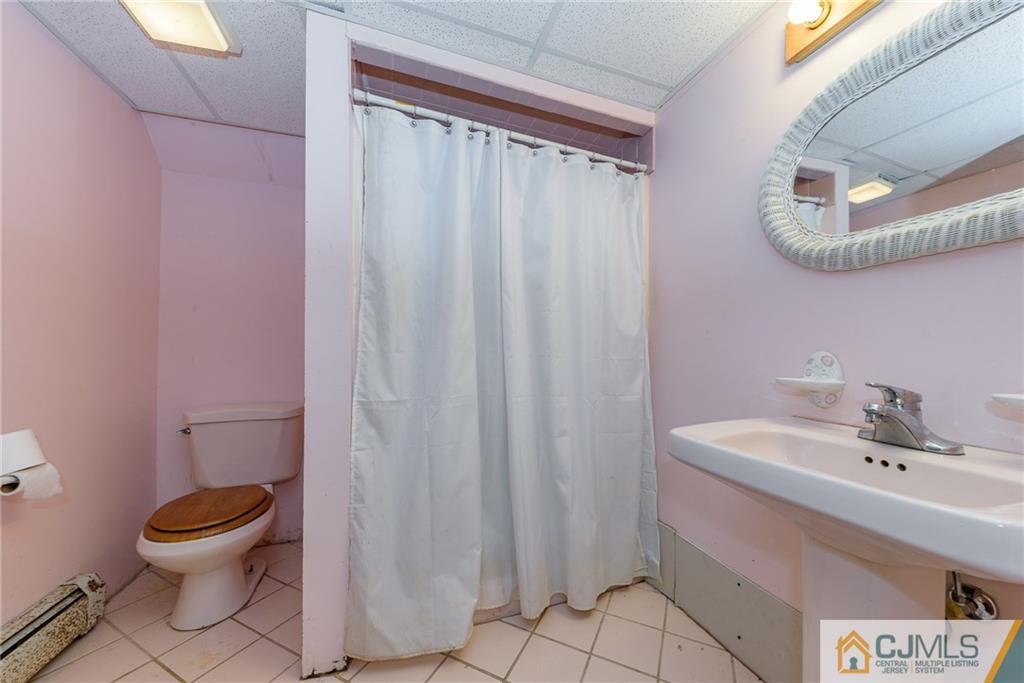 88 Emmans Road Ledgewood, NJ 07852 - Photo 9 of 25 a bathroom with a sink a toilet and shower curtain
