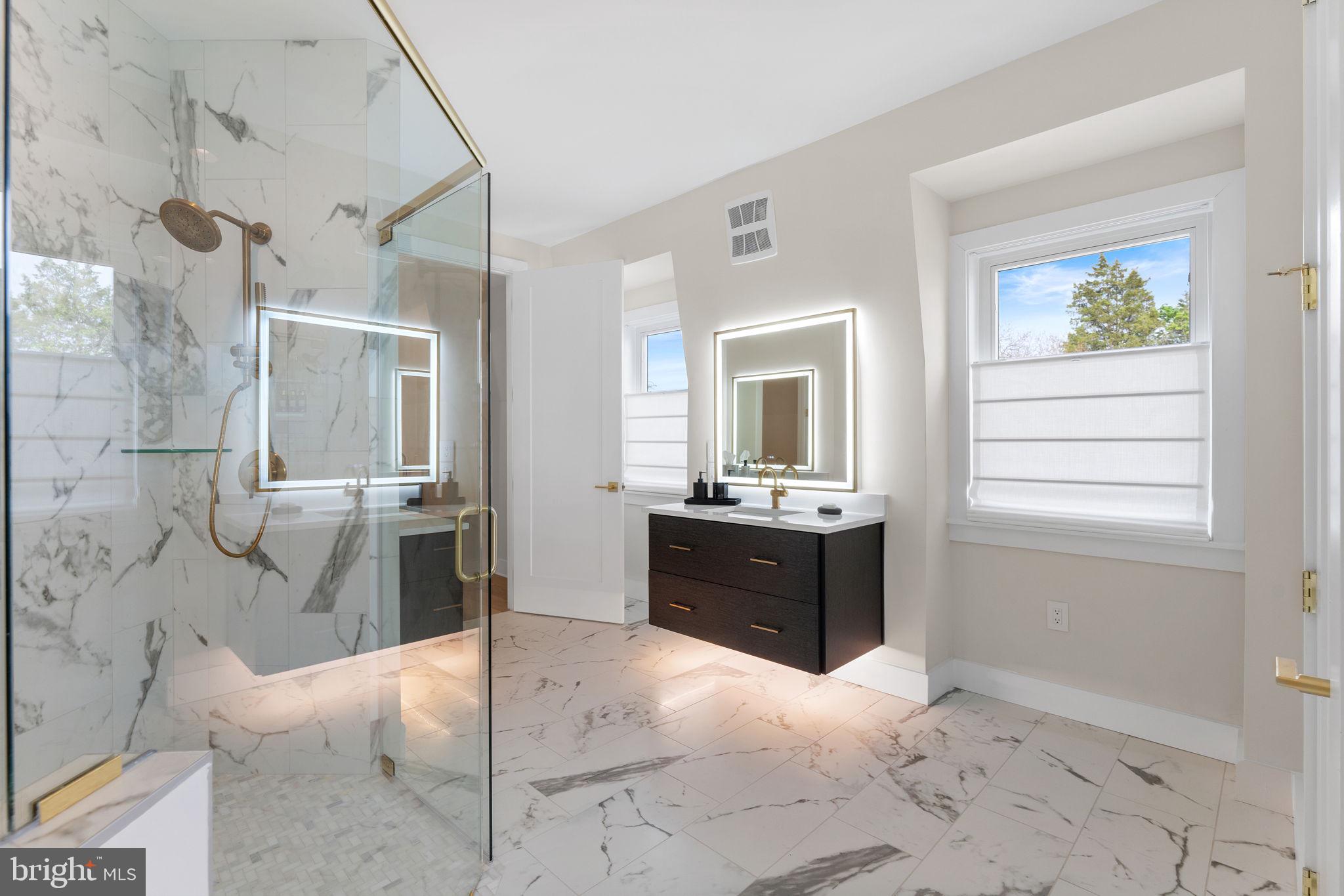 1620 Chain Bridge Road McLean, VA 22101 - Photo 27 of 68 a spacious bathroom with a granite countertop sink a mirror and a bathtub