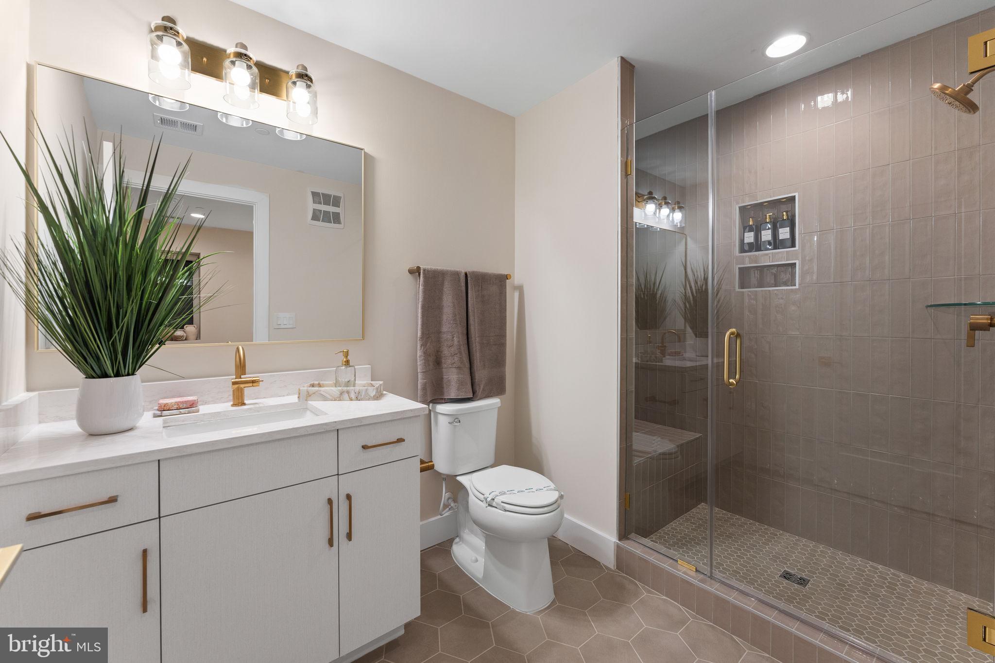 1620 Chain Bridge Road McLean, VA 22101 - Photo 33 of 68 a bathroom with a granite countertop sink a toilet and shower
