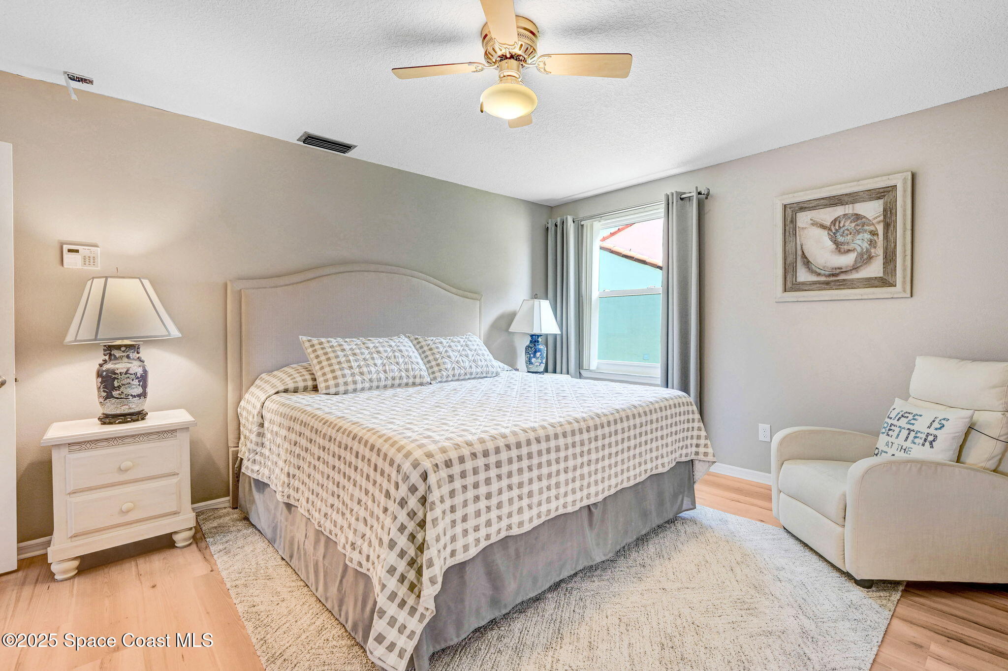 730 Spring Valley Drive Melbourne, FL 32940 - Photo 12 of 39 a bedroom with a bed and wooden floor