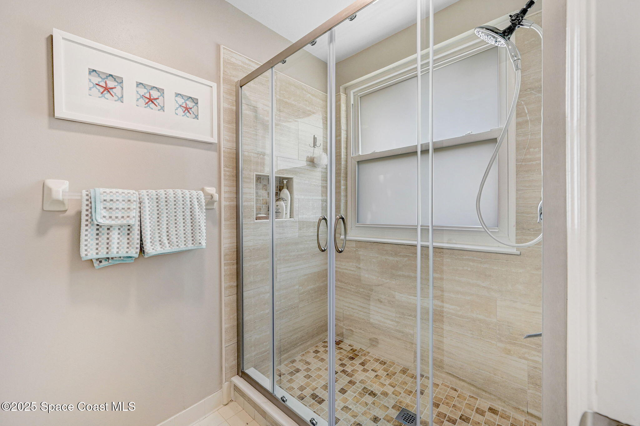 730 Spring Valley Drive Melbourne, FL 32940 - Photo 15 of 39 a bathroom with a glass shower door