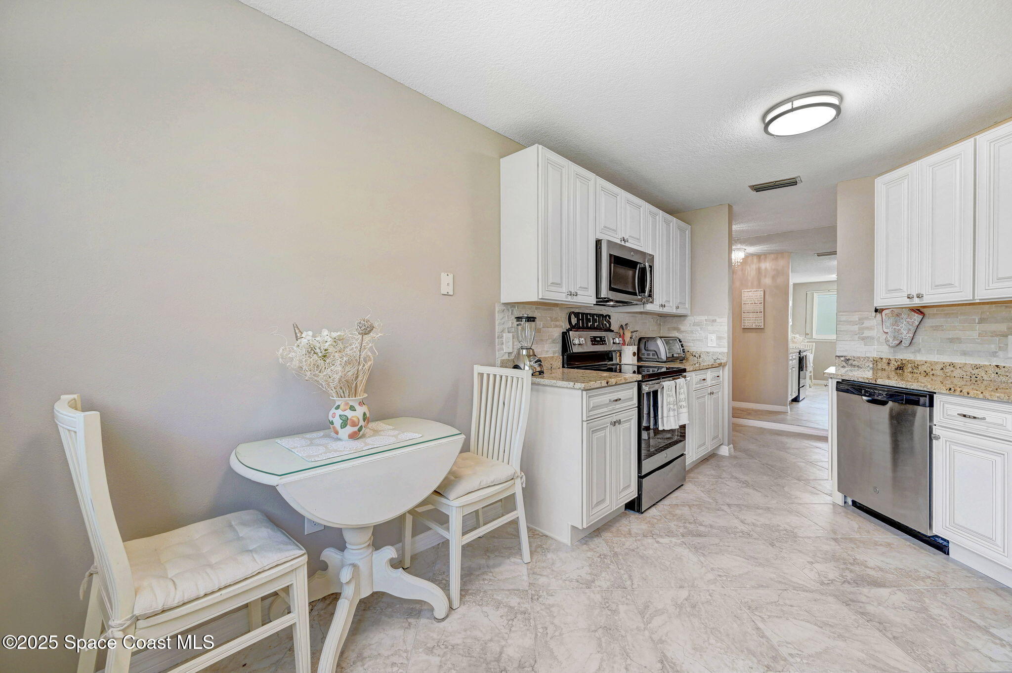 730 Spring Valley Drive Melbourne, FL 32940 - Photo 20 of 39 a kitchen with a sink cabinets and stainless steel appliances