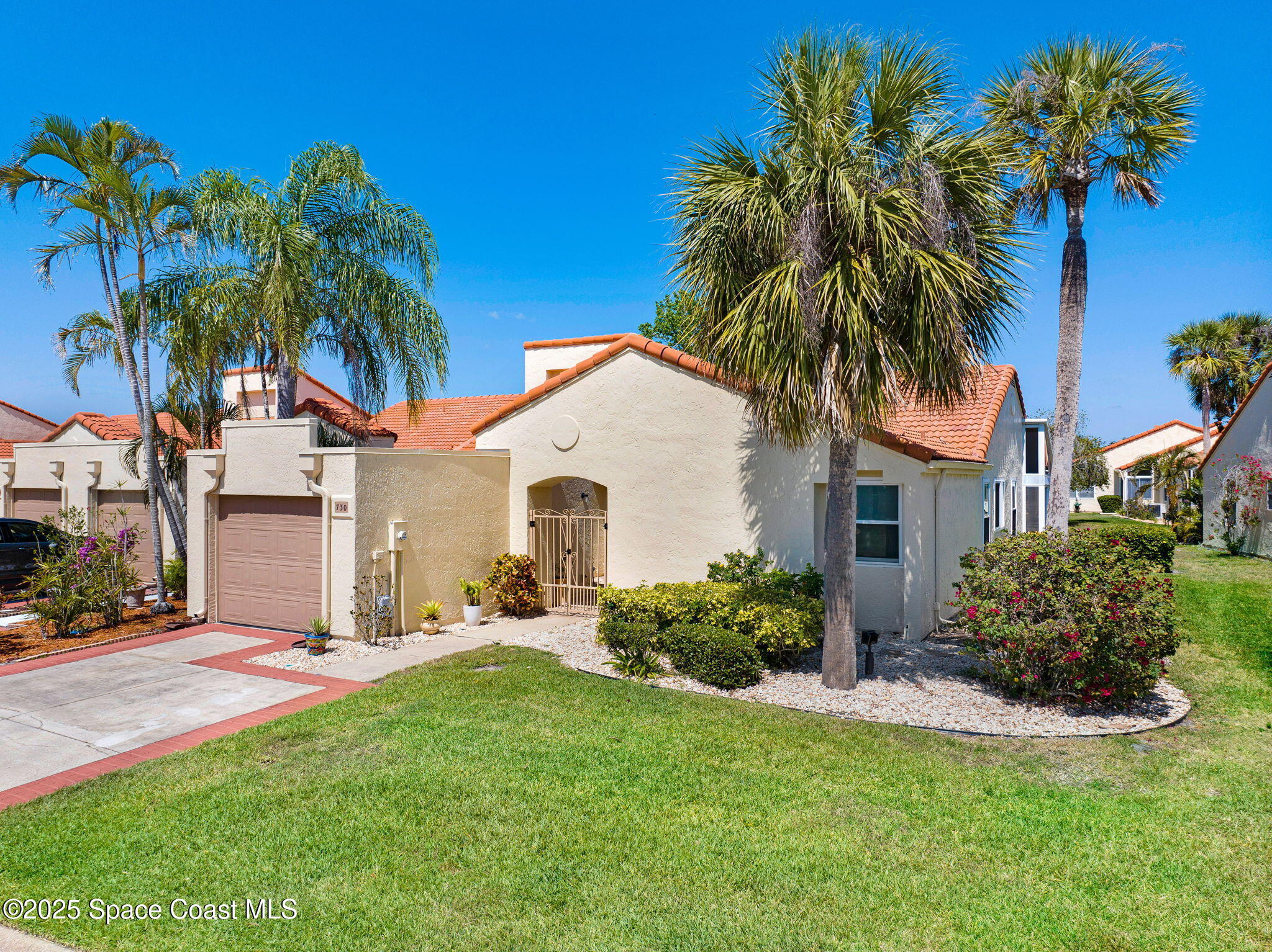 730 Spring Valley Drive Melbourne, FL 32940 - Photo 2 of 39 a front view of house with yard and green space