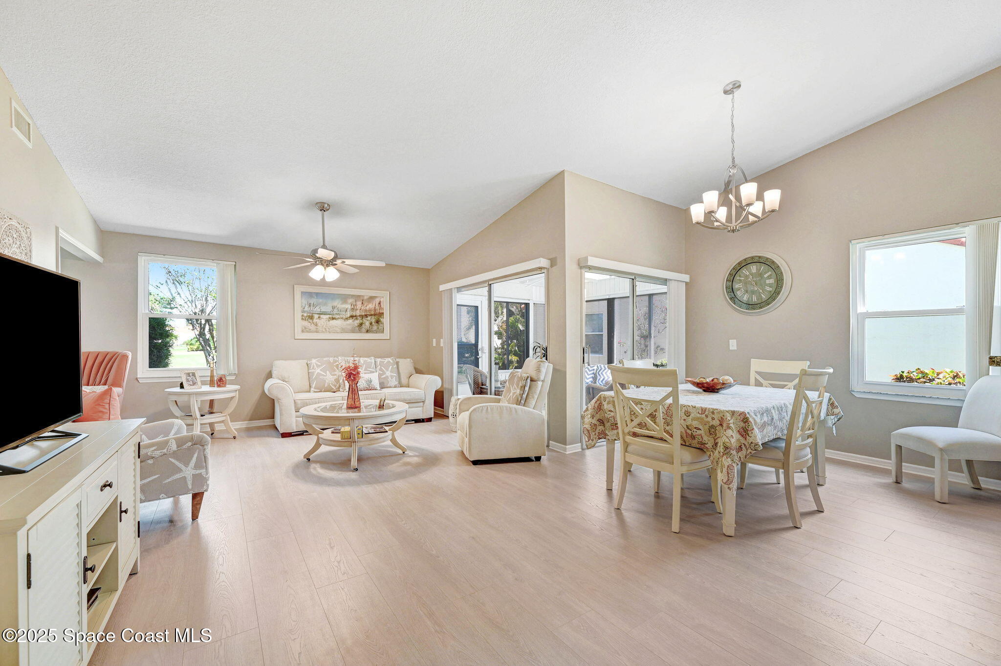 730 Spring Valley Drive Melbourne, FL 32940 - Photo 25 of 39 a living room with furniture chandelier and a flat screen tv