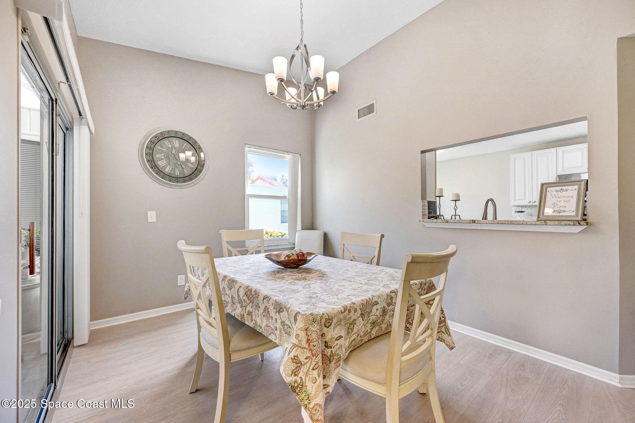 730 Spring Valley Drive Melbourne, FL 32940 - Photo 26 of 39 a view of a dining room with furniture and a chandelier