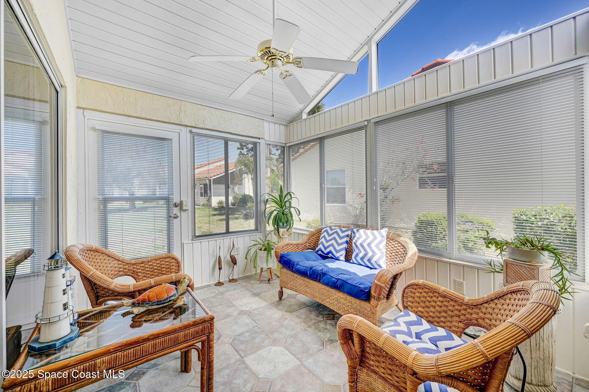730 Spring Valley Drive Melbourne, FL 32940 - Photo 27 of 39 a living room with furniture and a floor to ceiling window