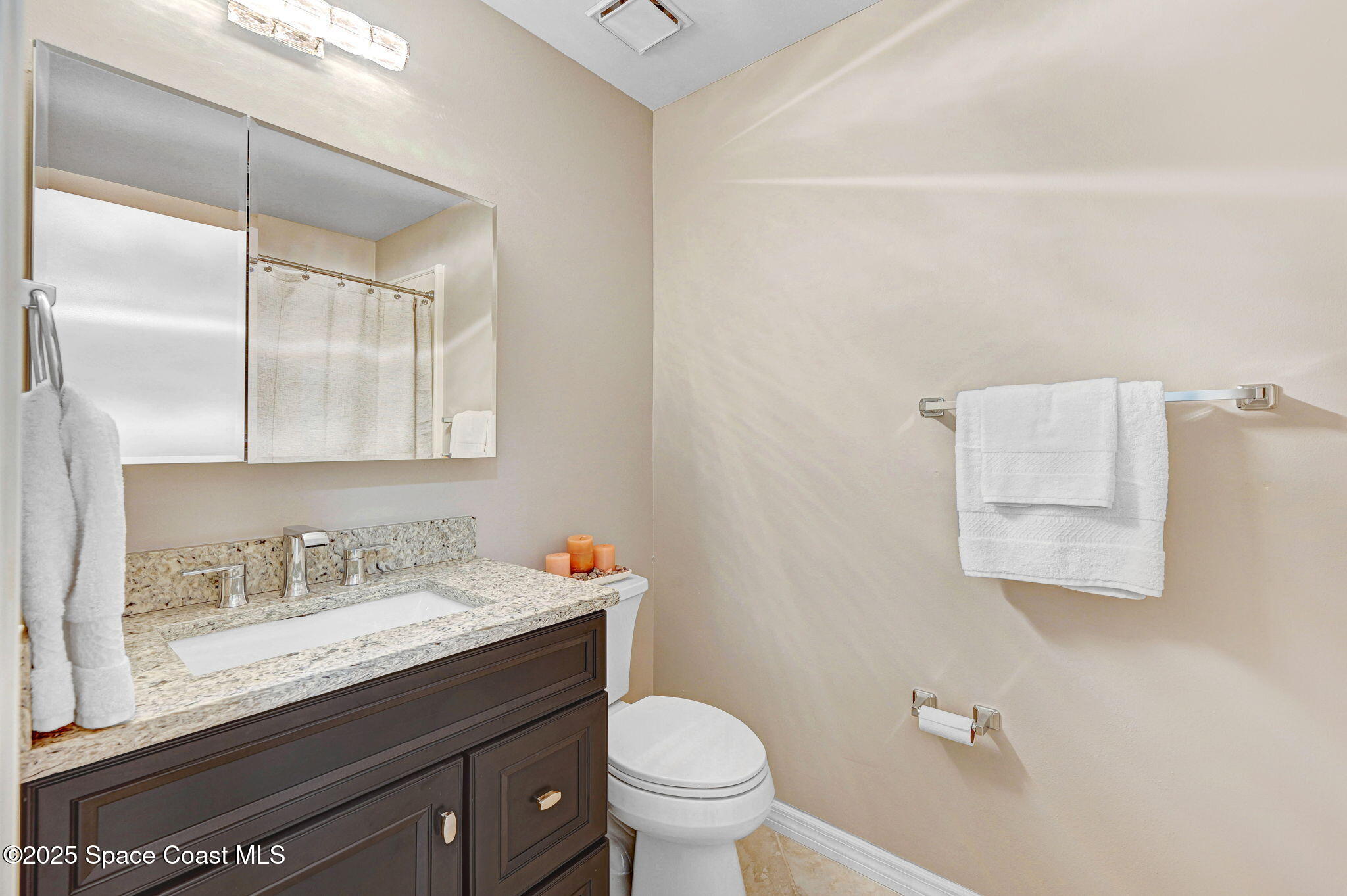 730 Spring Valley Drive Melbourne, FL 32940 - Photo 34 of 39 a bathroom with a granite countertop sink a toilet and a mirror