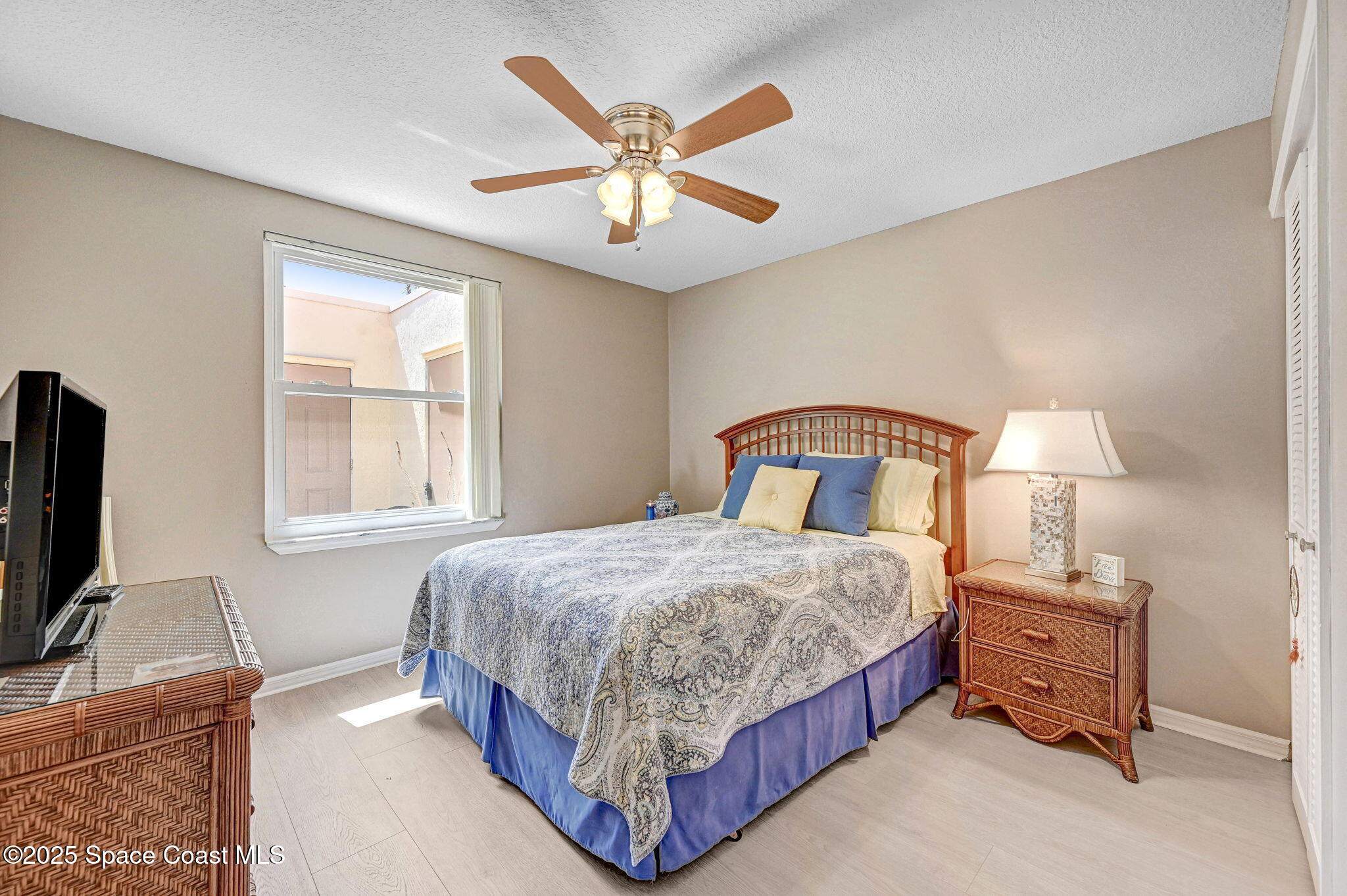 730 Spring Valley Drive Melbourne, FL 32940 - Photo 35 of 39 a bedroom with a bed and a chandelier