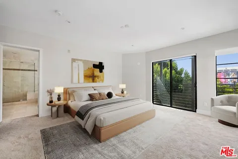 a bedroom with a large bed and a couch