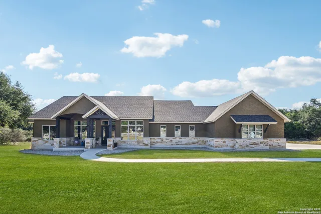 a front view of a house with swimming pool having outdoor seating