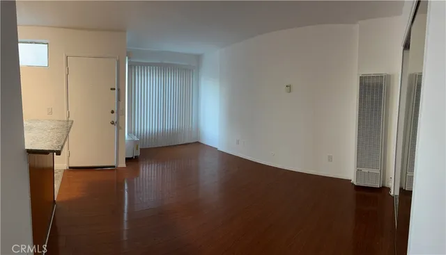 an empty room with wooden floor
