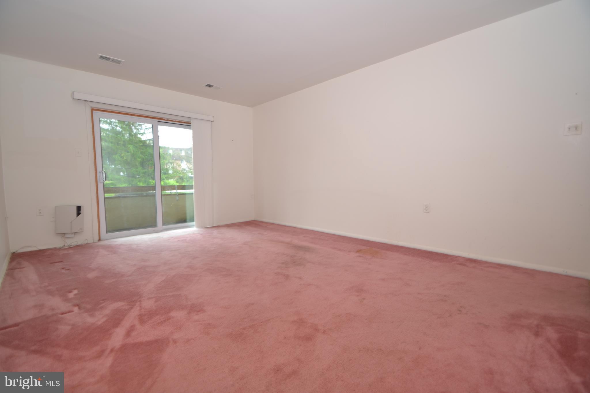 3922 Rolling Rd., Unit A5 Baltimore, MD 21208 - Photo 2 of 8 a view of an empty room with a window