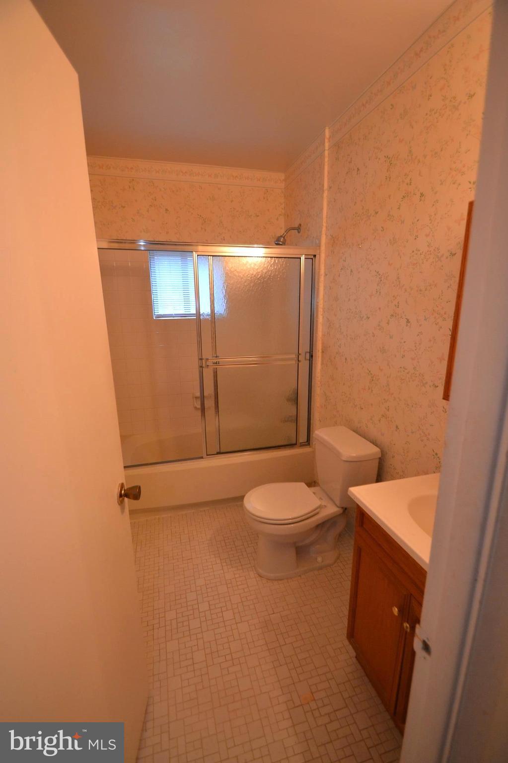 3922 Rolling Rd., Unit A5 Baltimore, MD 21208 - Photo 6 of 8 a bathroom with a toilet a sink and shower