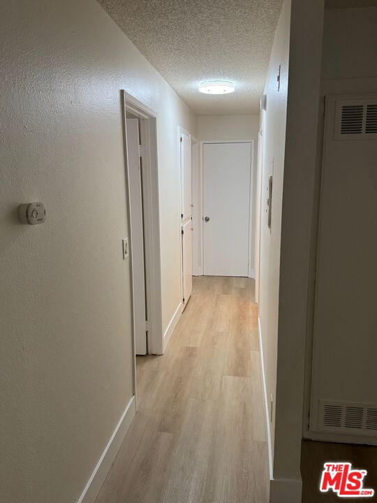 428 South Grand View Street Los Angeles, CA 90057 - Photo 11 of 29 a view of hallway with wooden floor