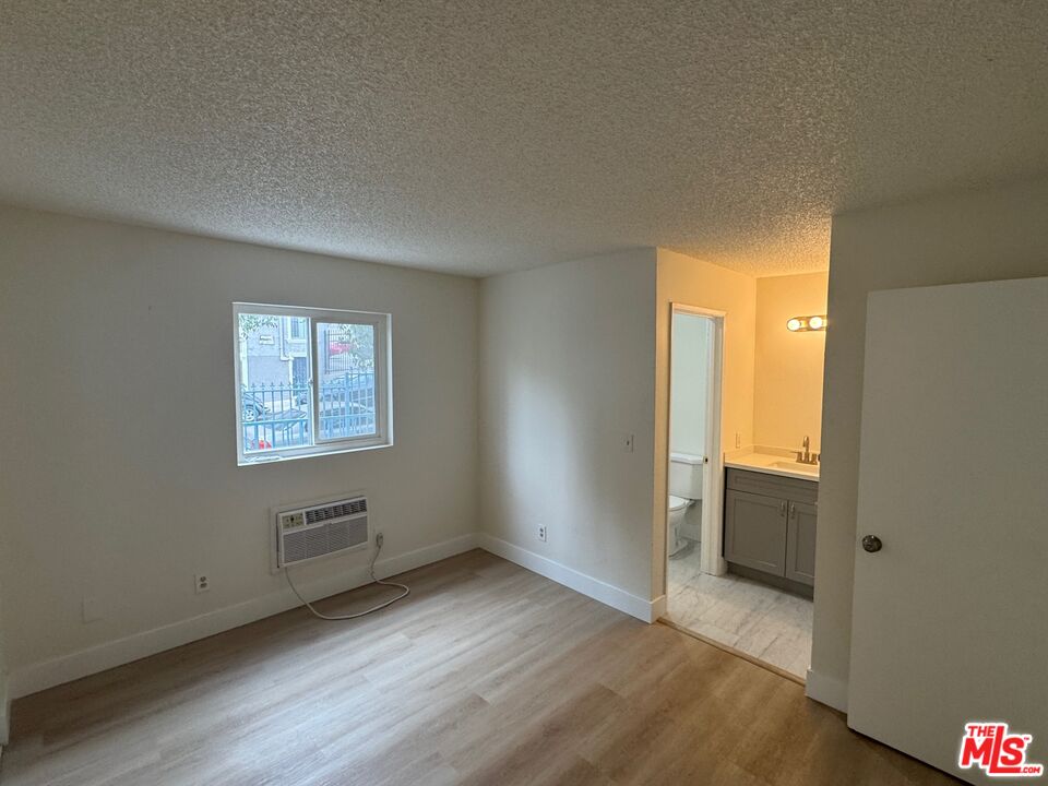 428 South Grand View Street Los Angeles, CA 90057 - Photo 13 of 29 an empty room with wooden floor and windows